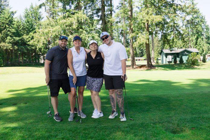 4 WSECU people posing for a photo on a golf course