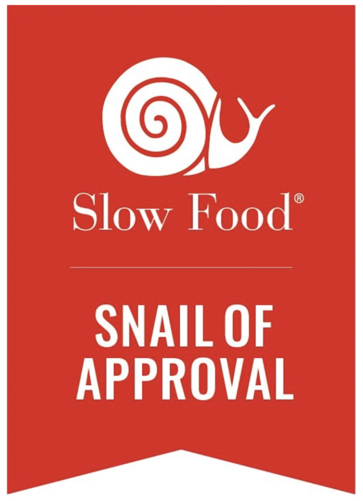 Red banner logo with a white drawing of a snail at the top and the words, 'slow food snail of approval'