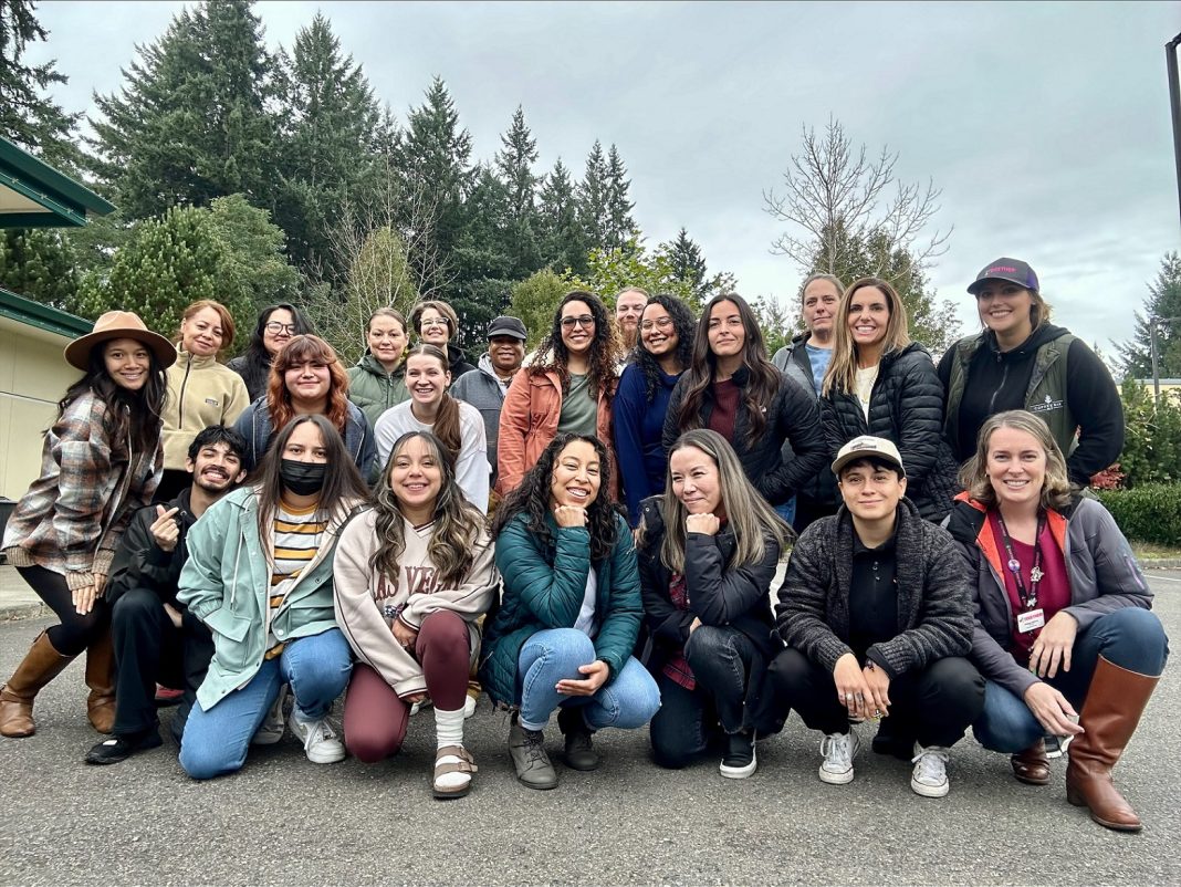 TOGETHER! group photo outside with trees in the background