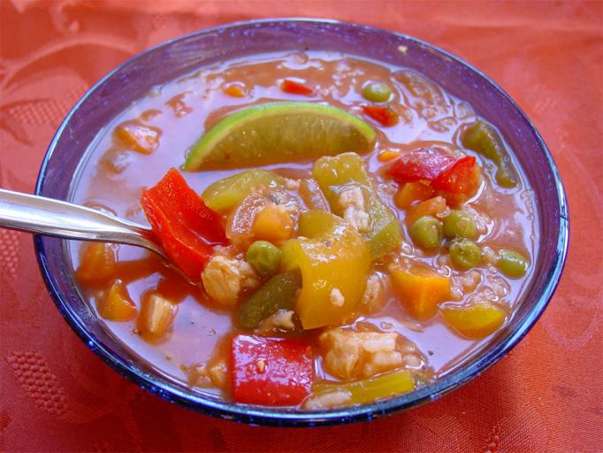 a bowl of soup on a red tablecloth