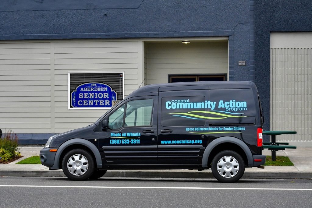 Meals on Wheels van parked outside a building
