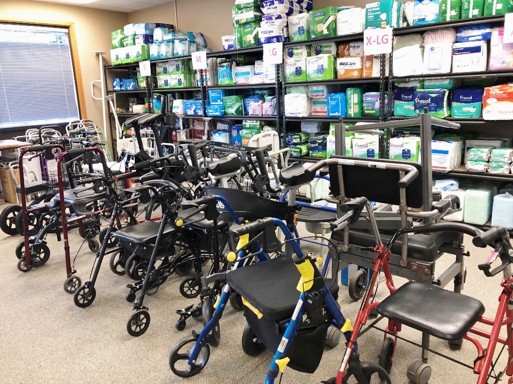 metal shelves full of medical equipment with walkers lined up in front of them