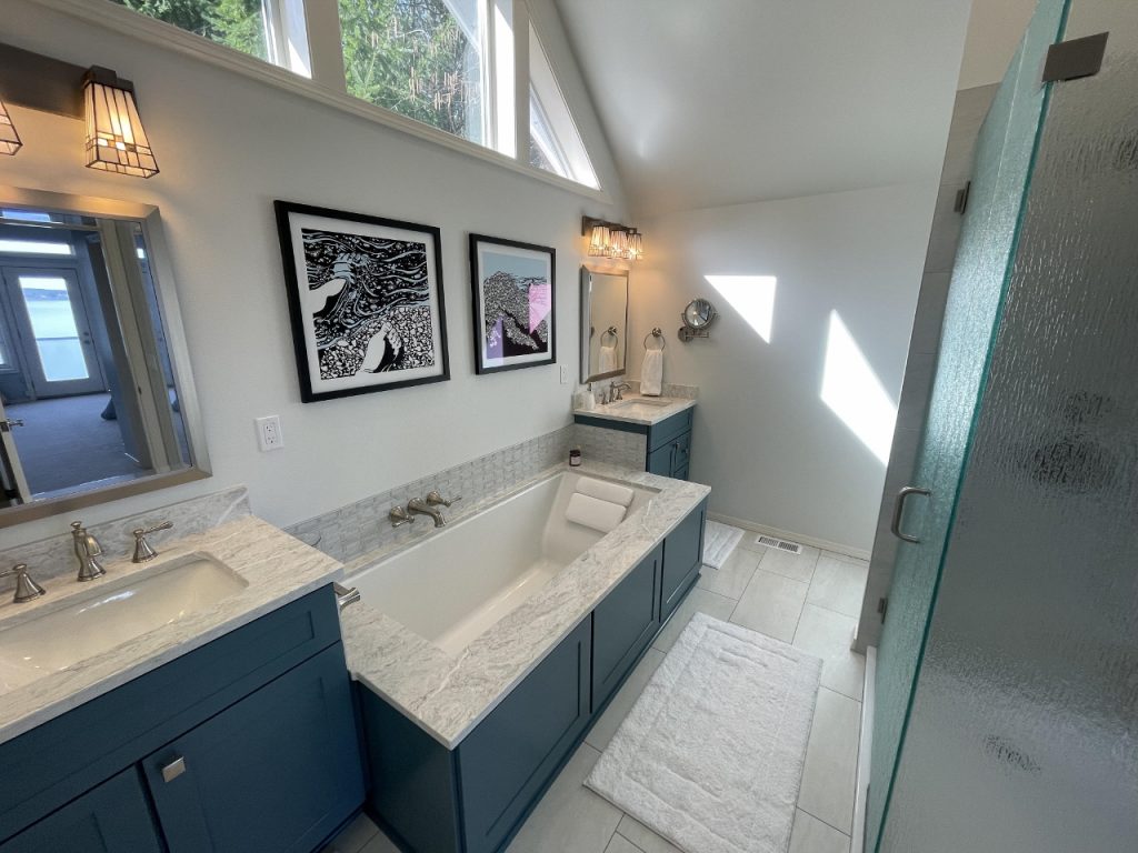 a bathroom tub, and sink down in blue and white tile