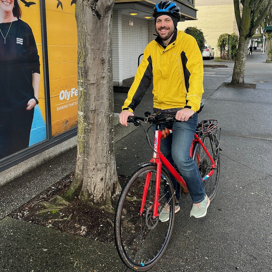 Mike Bowen standing on his bike next to a tree