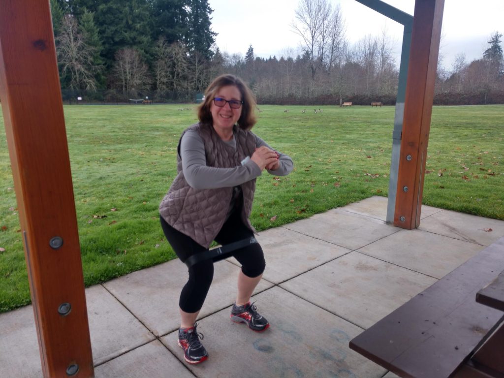 Rachel Hofmeister doing a squat with a resistance loop 