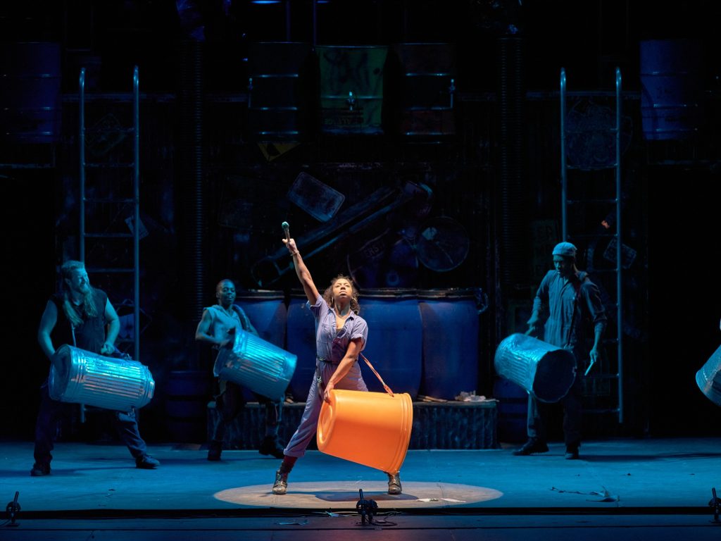 STOMP performing on stage with garbage cans