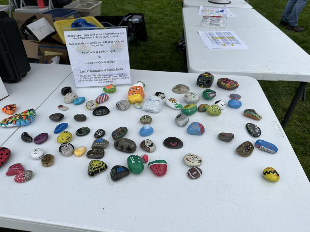 a bunch of colorfully painted rocks on a white table