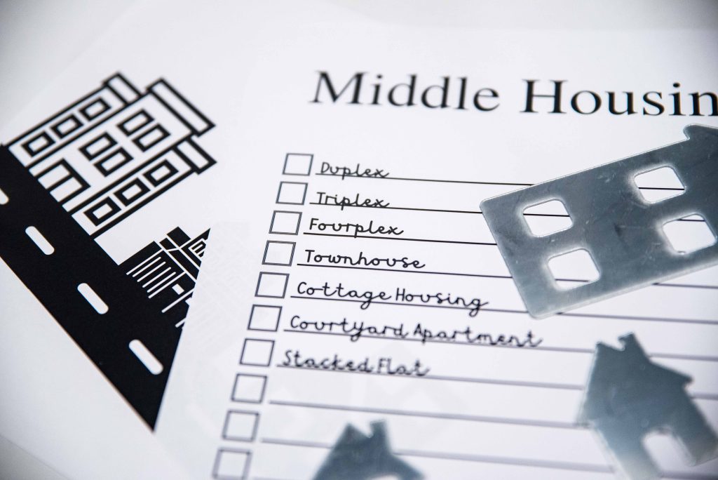 white pieces of paper that say middle housing and have black and white drawings of houses on them