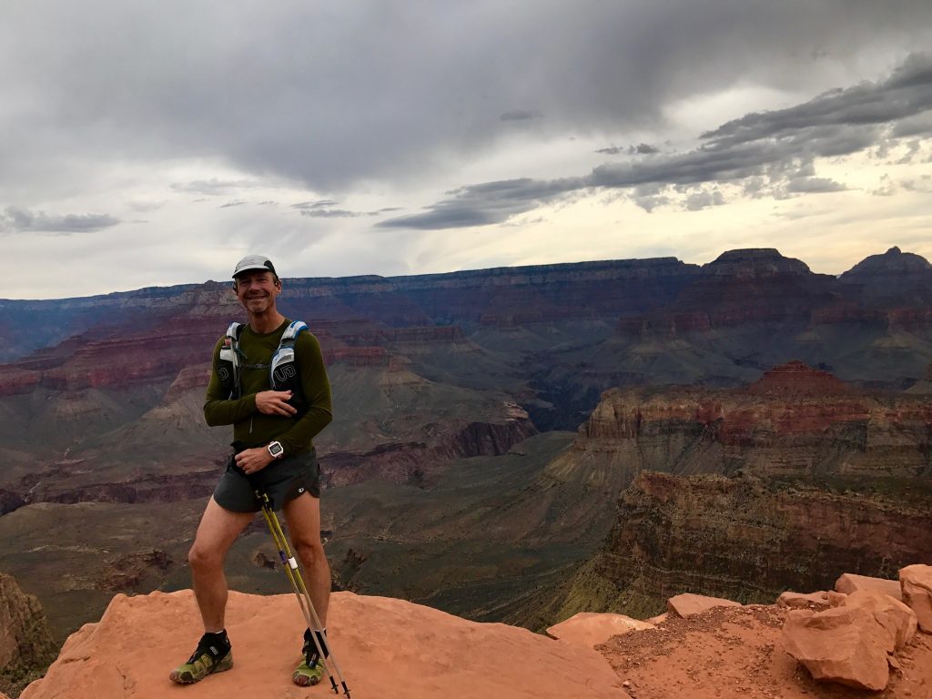 Tom Helpenstell standing on by the Grand Canyon