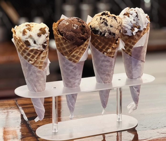 four ice cream cones in a stand