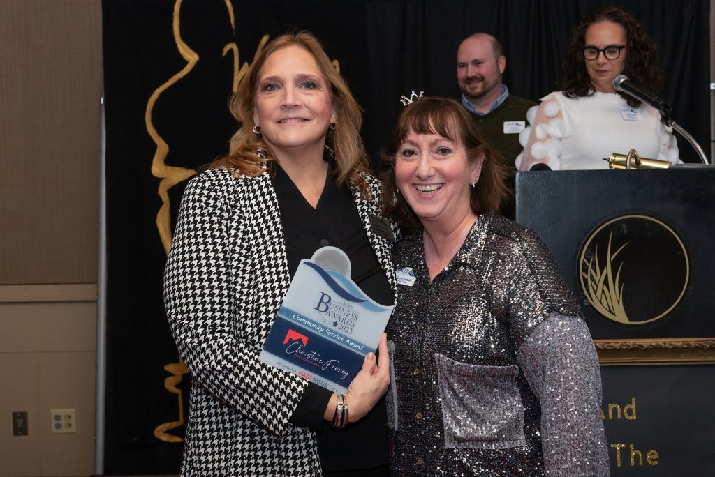 Christine Forrey poses for photo with plaque from Lacey South Sound Chamber awards