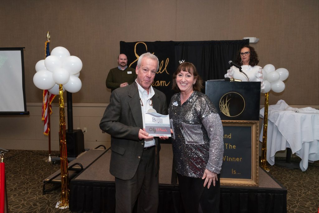 Ed Schlich, founder of Oly WInes and winner of Entrepreneur of the Year poses for photo with plaque from Lacey South Sound Chamber awards