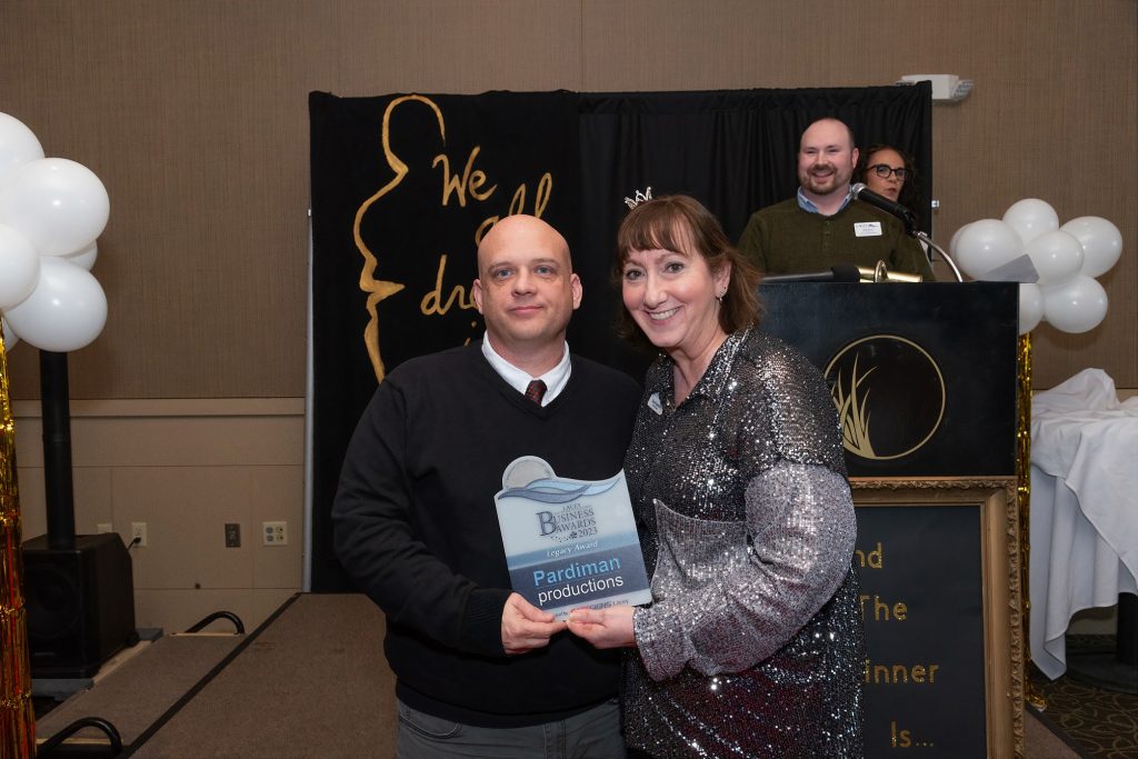 Corey Lopardi of Pardiman Productions poses for photo with plaque from Lacey South Sound Chamber awards