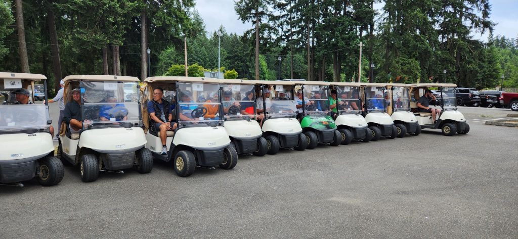 line of golf carts in a parking lot