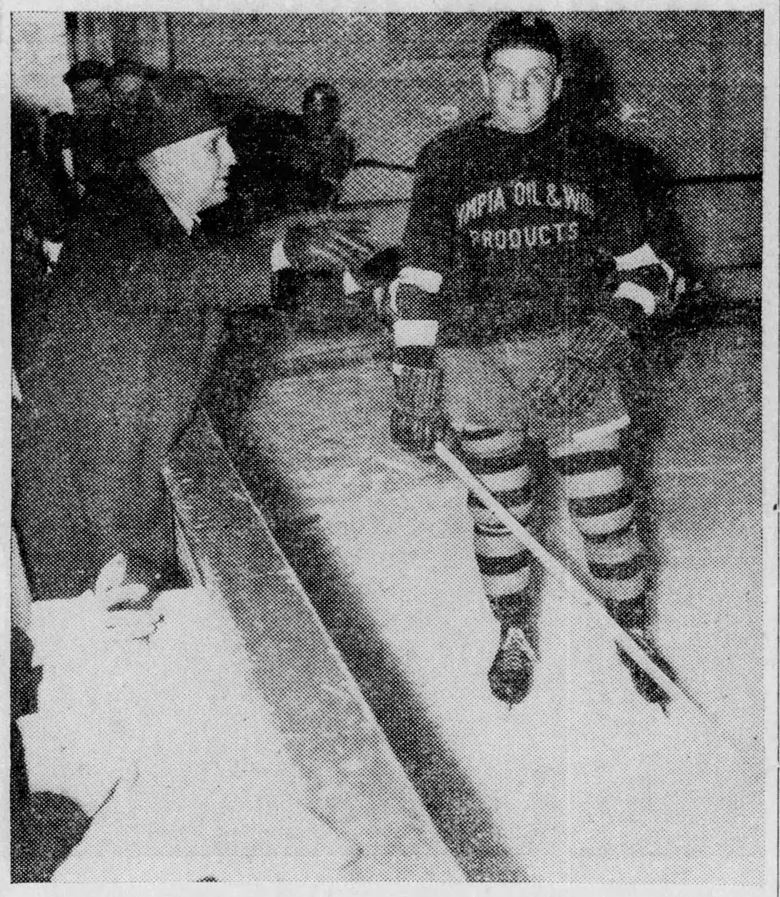 black and white photo of men playing hockey in 1939.