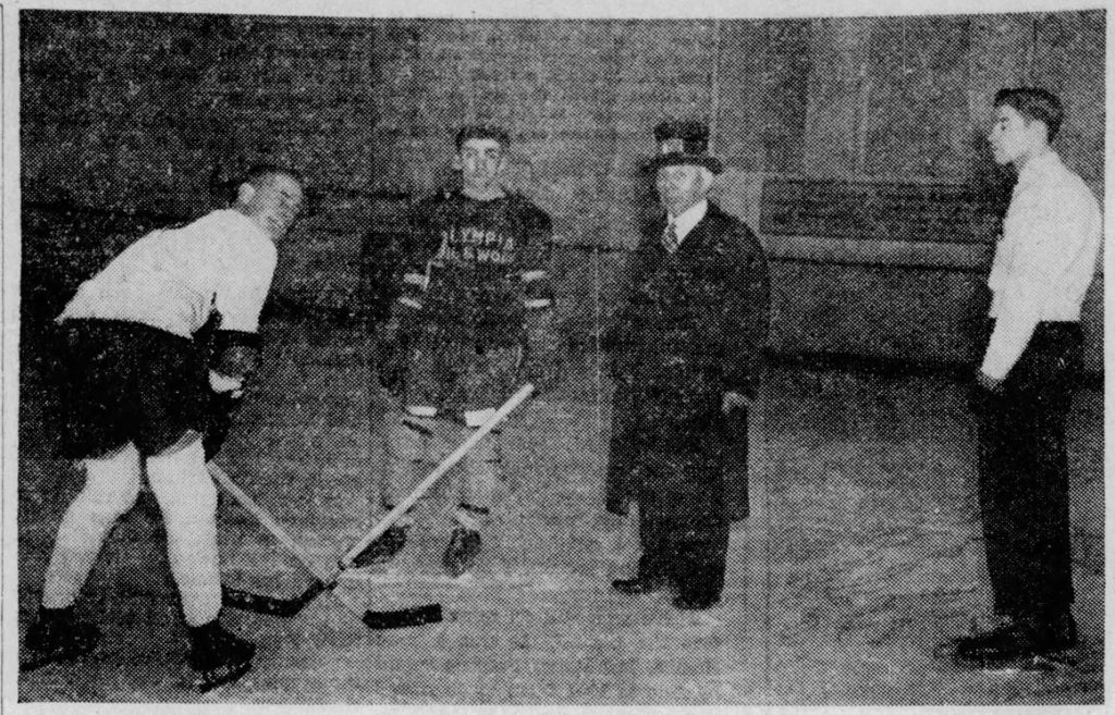 black and white photo of men playing hockey in 1939.