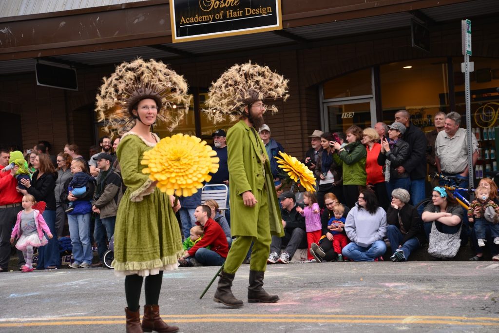 people dressed as dandelions for Olympia's Procession of the species