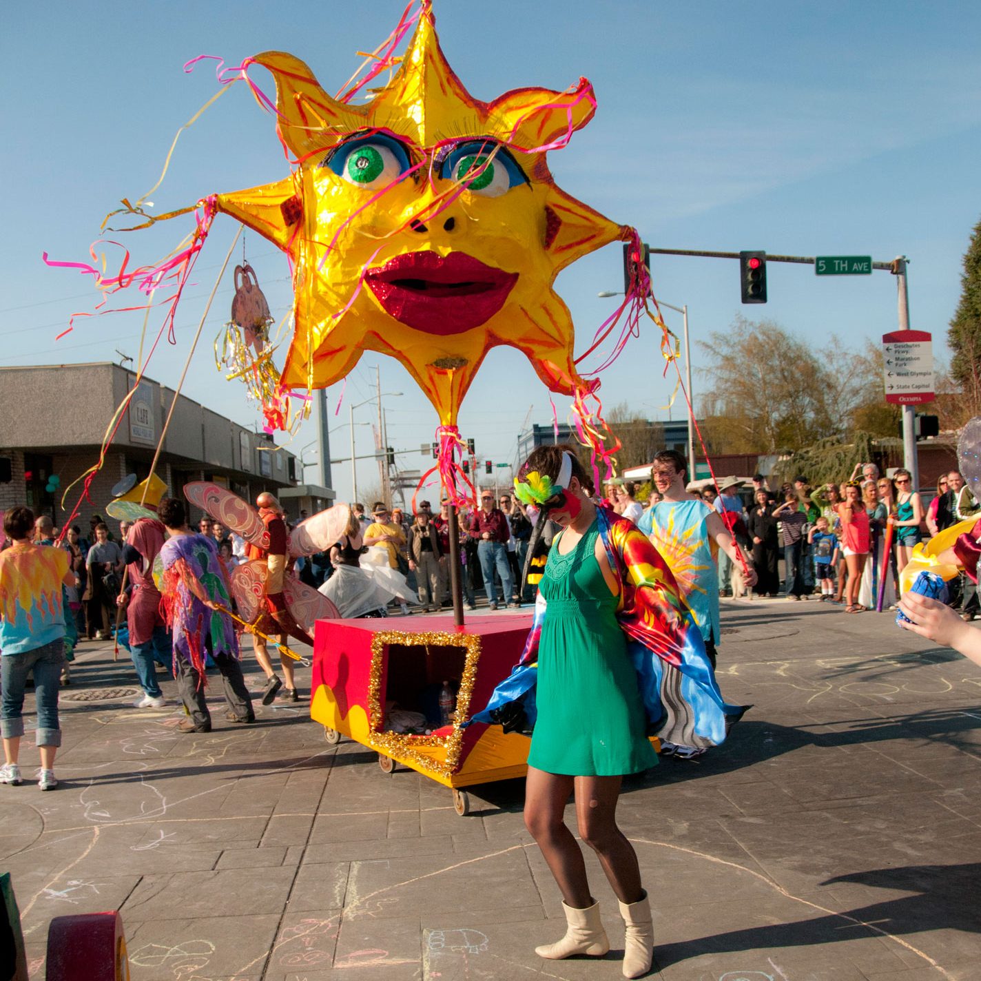 People with a large sun 'float' for Olympia's Procession of the species