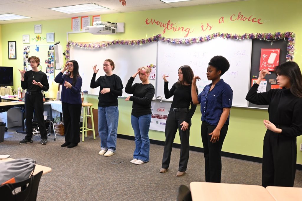 River Ridge High School ASL 3 students signing in front of  a classroom