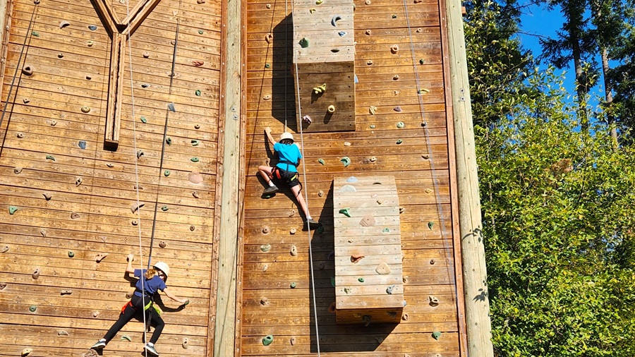 students on a large climbing wall