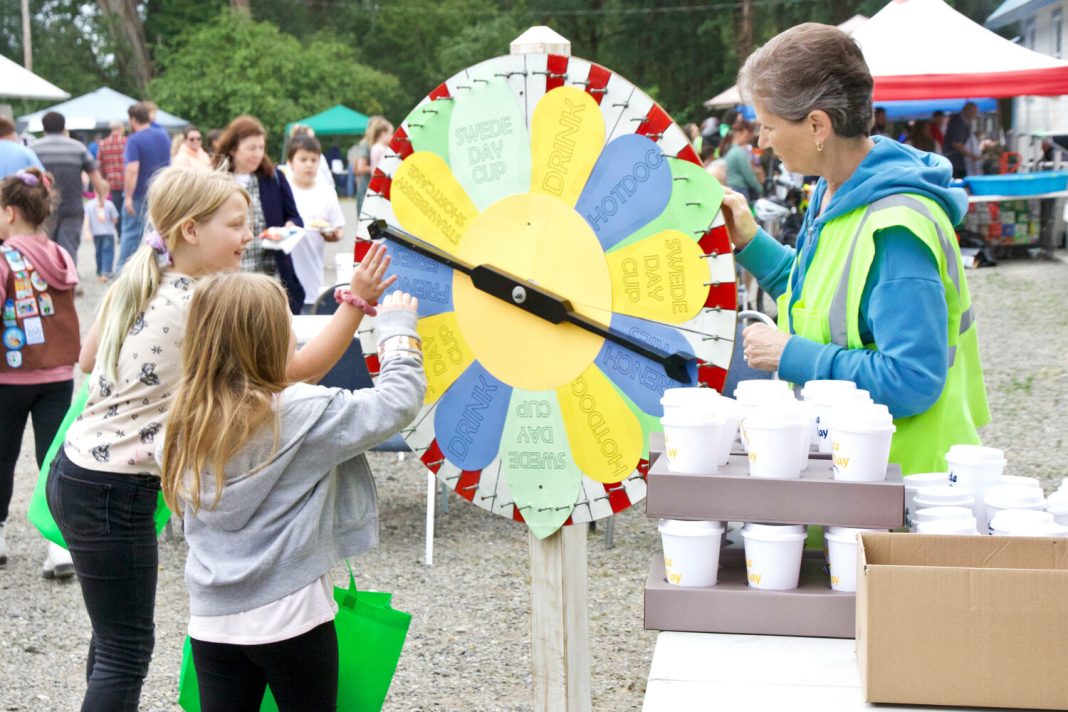 group of kids spinning a large cardboard prize spinner