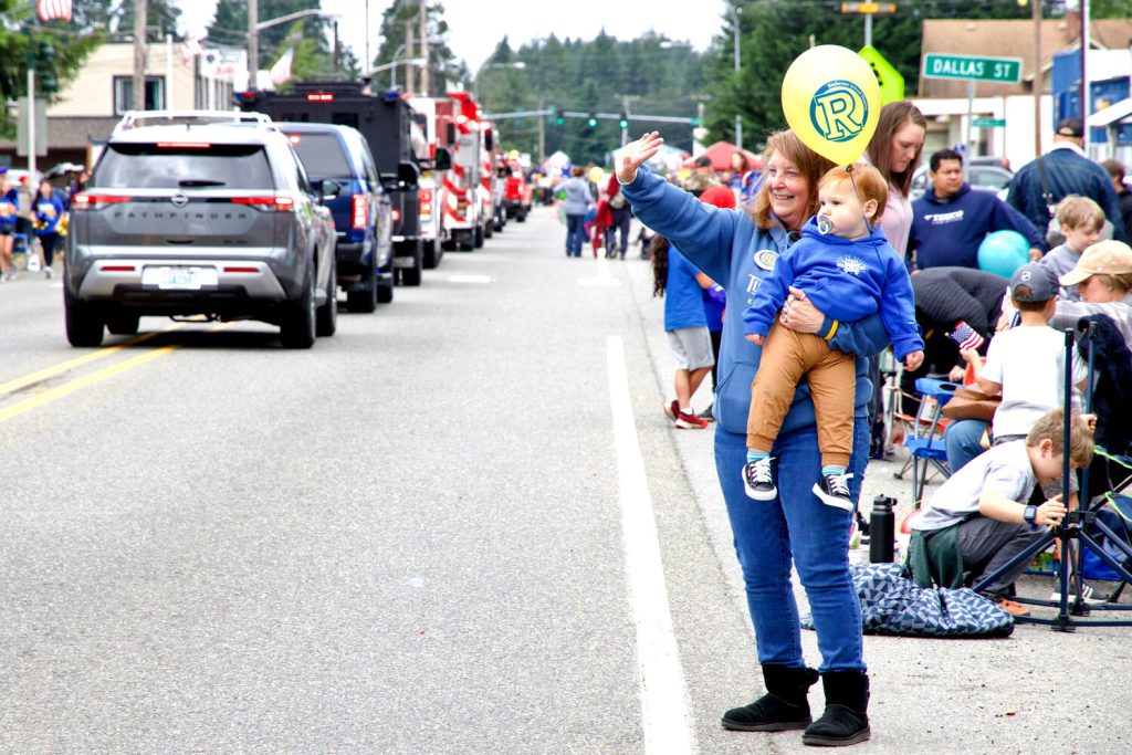 people lined up along with road, watching the Rochester’s Swede Day Mid-Sommer Festival parade