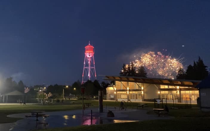 fireworks light up the night sky over Yelm, the historic water tour is seen to the left.