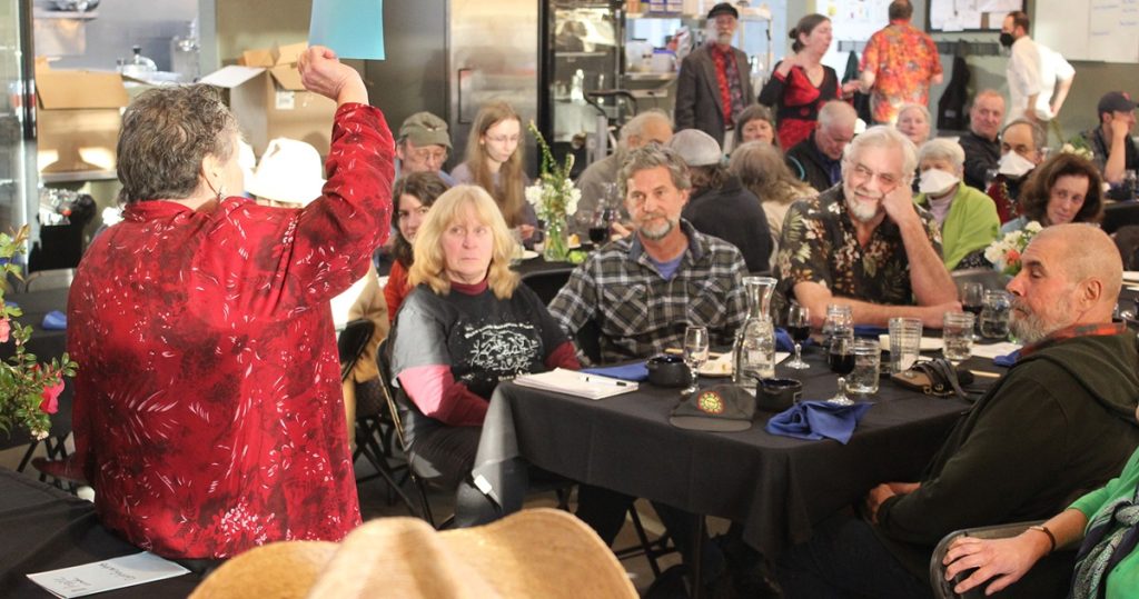 people sitting at large tables at an auction
