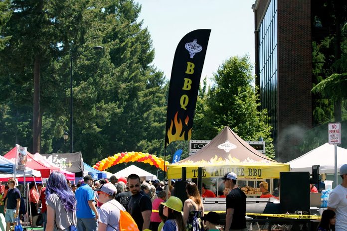 Lacey-South-Sound-BBQ-Festival-community-buy-local Large crowd mingles through tents at the Lacey South Sound BBQ Festival