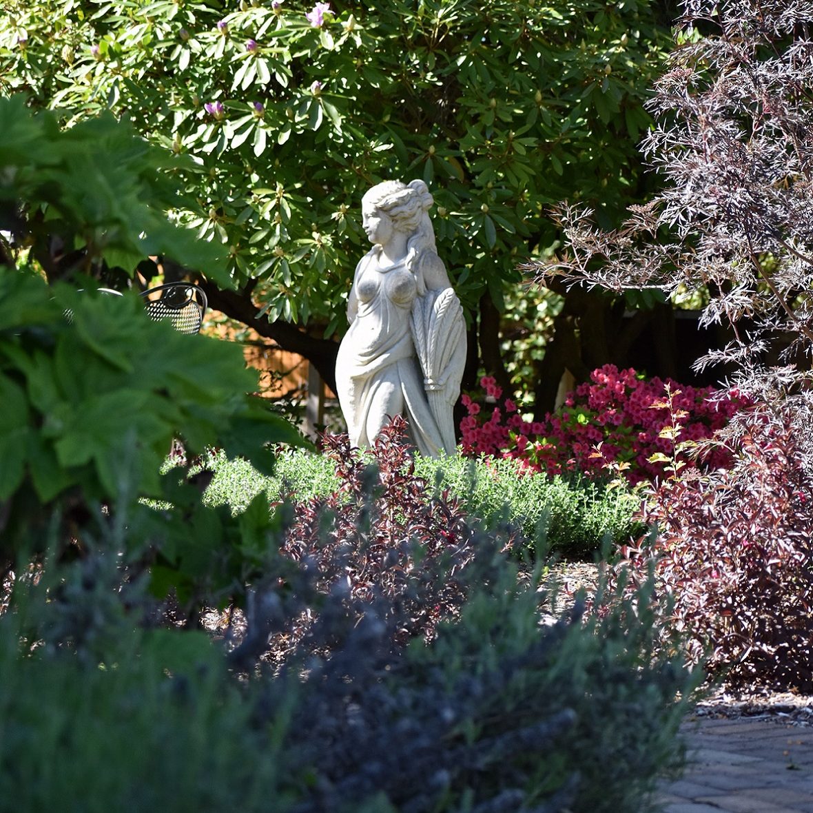 a statue of a woman in the garden at The Marie Bed & Breakfast in Olympia