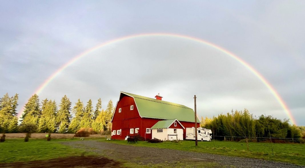 Big Red Barn at Summit Farms with a full rainbow arching over it