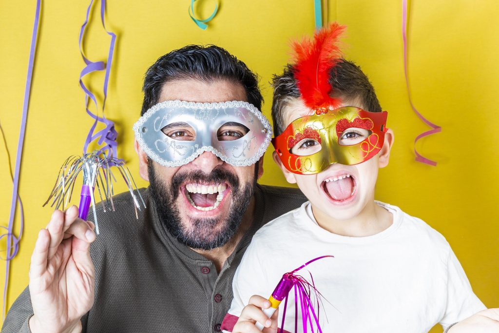 a man and a child with eye masks on for a party