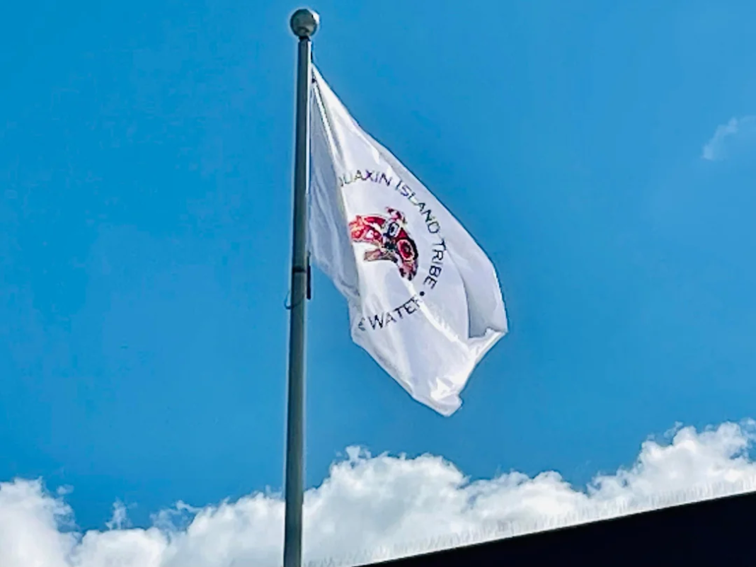 Squaxin Island Tribe Flag flying over a building