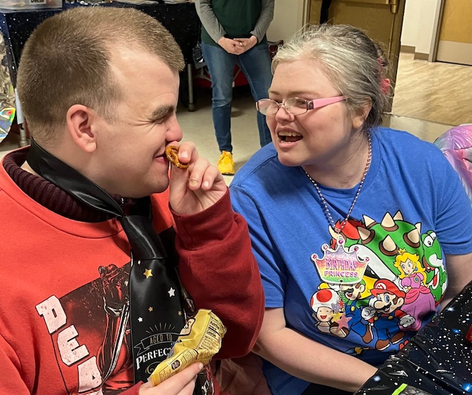 two people sitting in chairs laughing