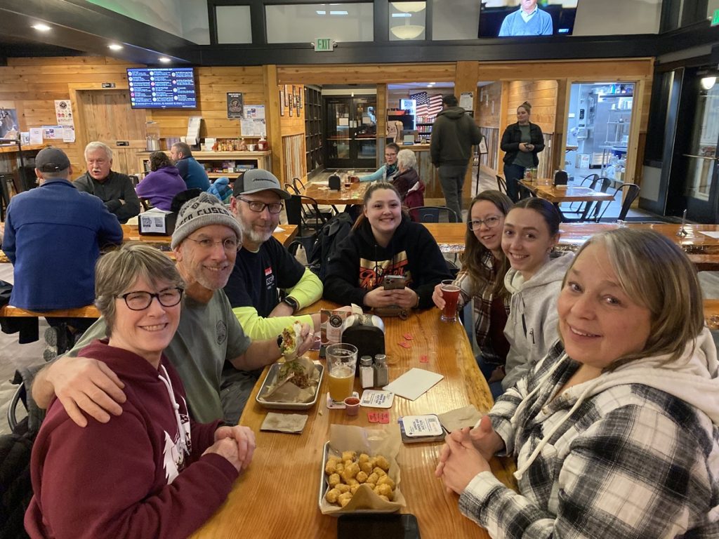 People at a table smiling for the camera at 507