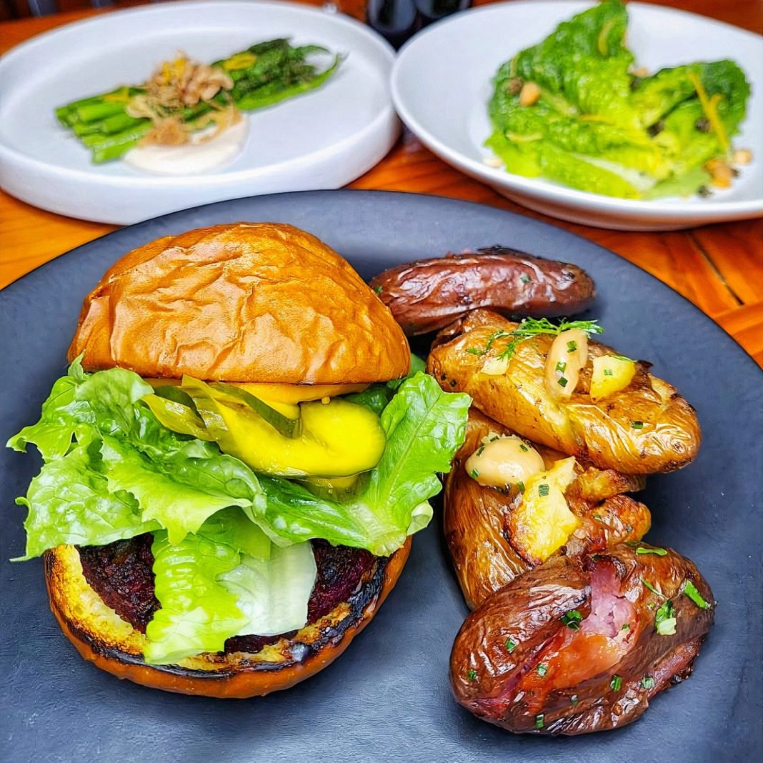 vegan burger on a plate with fries at The Park Side Cafe