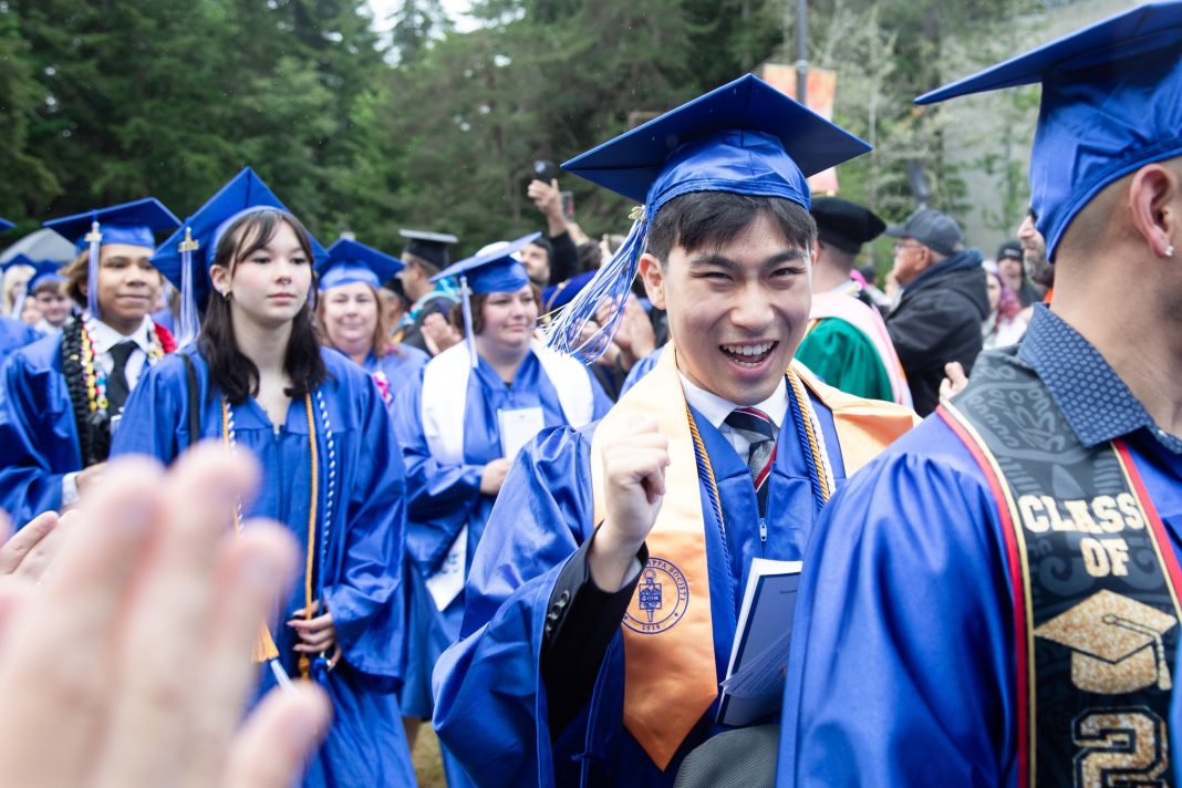 line of SPSCC graduates in their blue caps and gowns