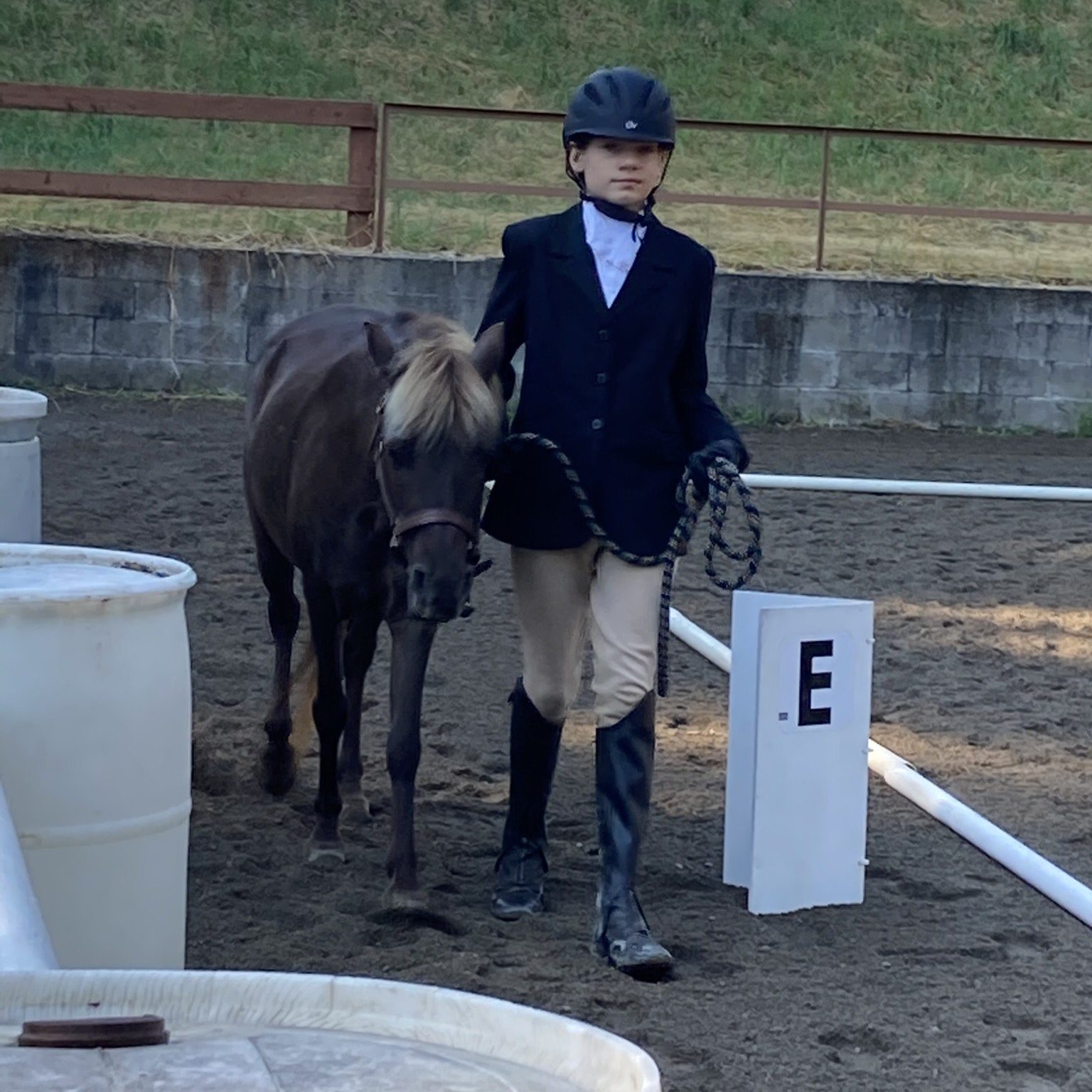 Kylan leading his horse Rosie in the arena at the Thurston County Fairgrounds