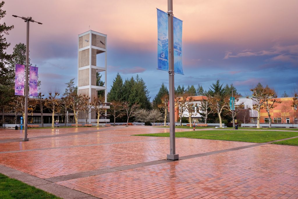 courtyard with banners and a clock tower at The Evergreen State College