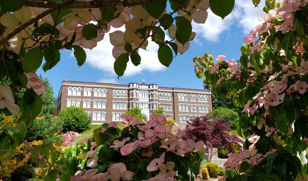 Saint Martin's University Old Main Building seen through flowering dogwoods
