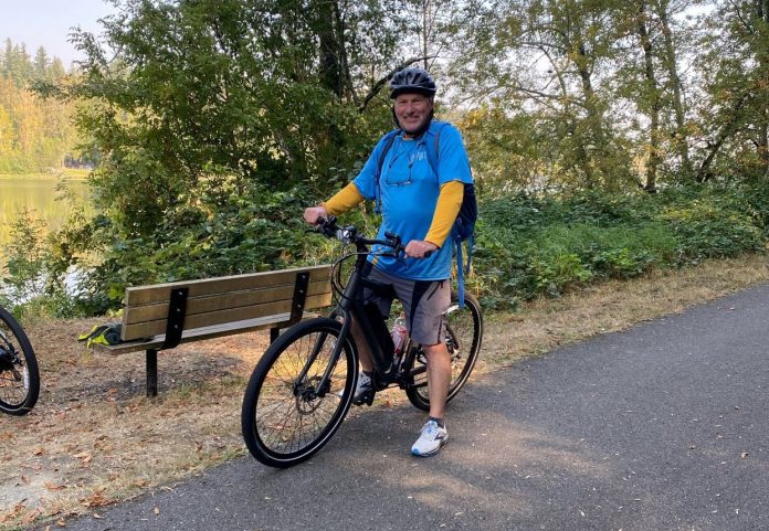 E-Bikes-Chehalis-Western-Trail-Jay-Barney man straddling his bike on the paved Chehalis Western Trail