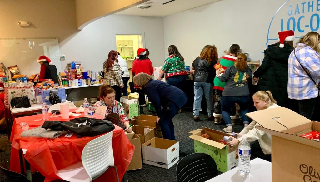 South Sound Parent to Parent volunteers sorting groceries and repacking for holiday food drive