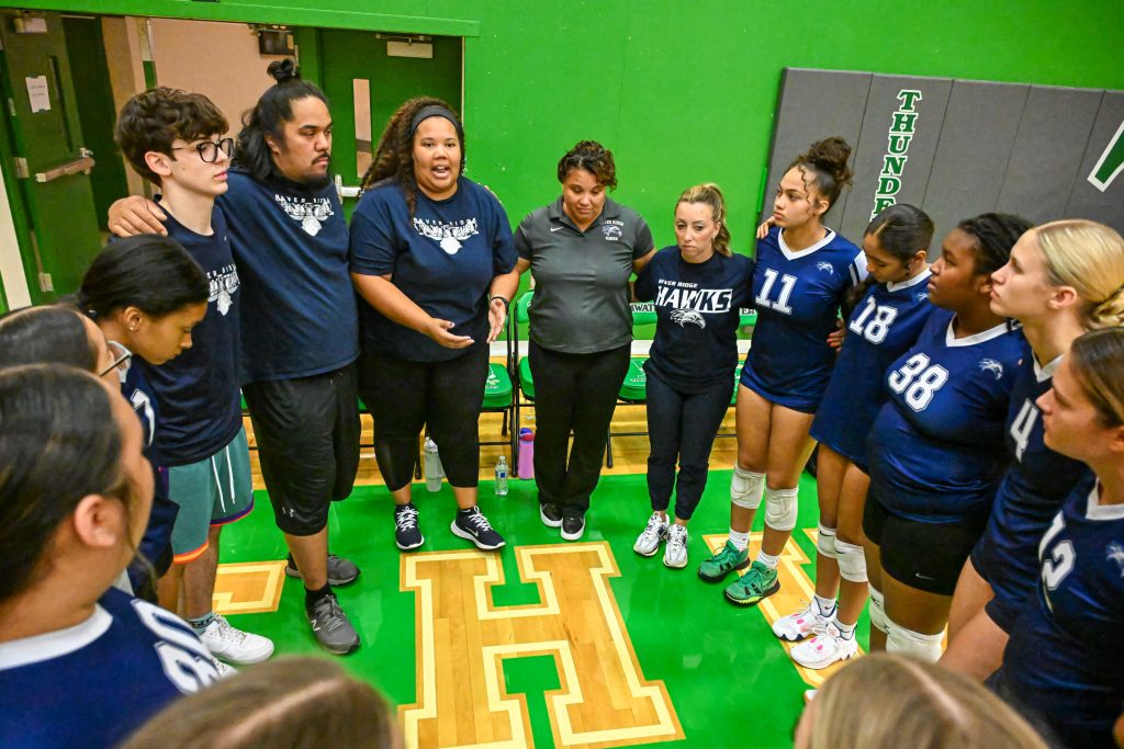 Girls standing in a circle in a locker room