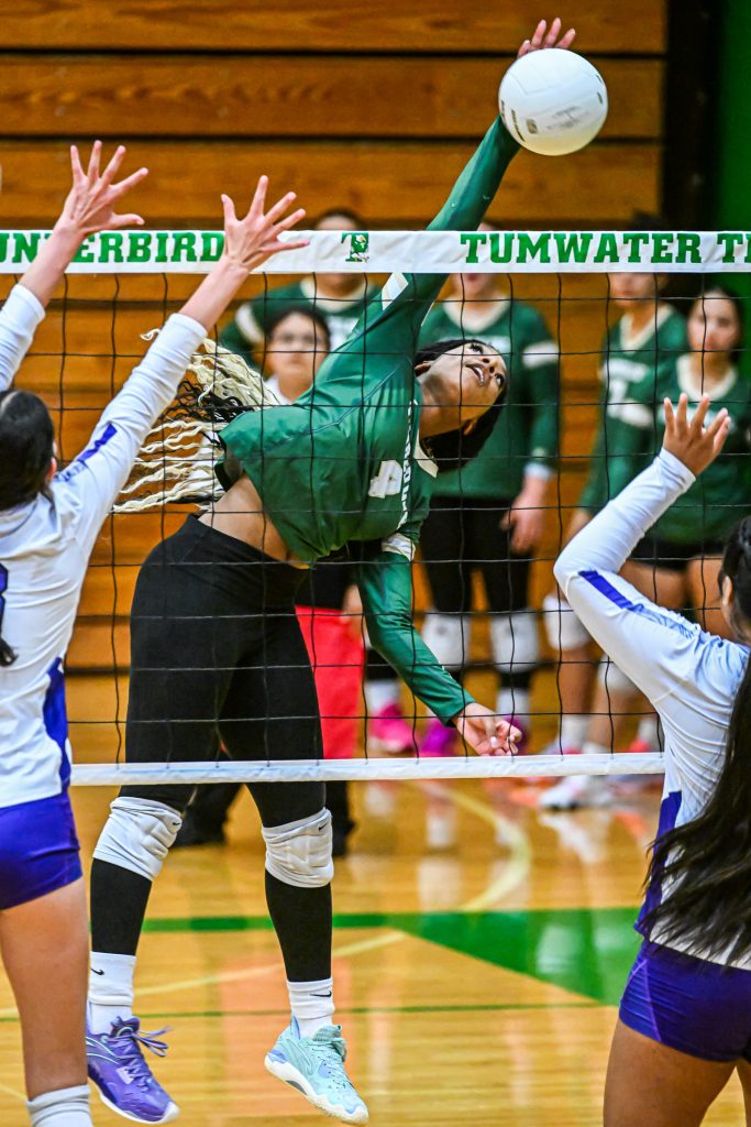 girls at the net blocking during volleyball