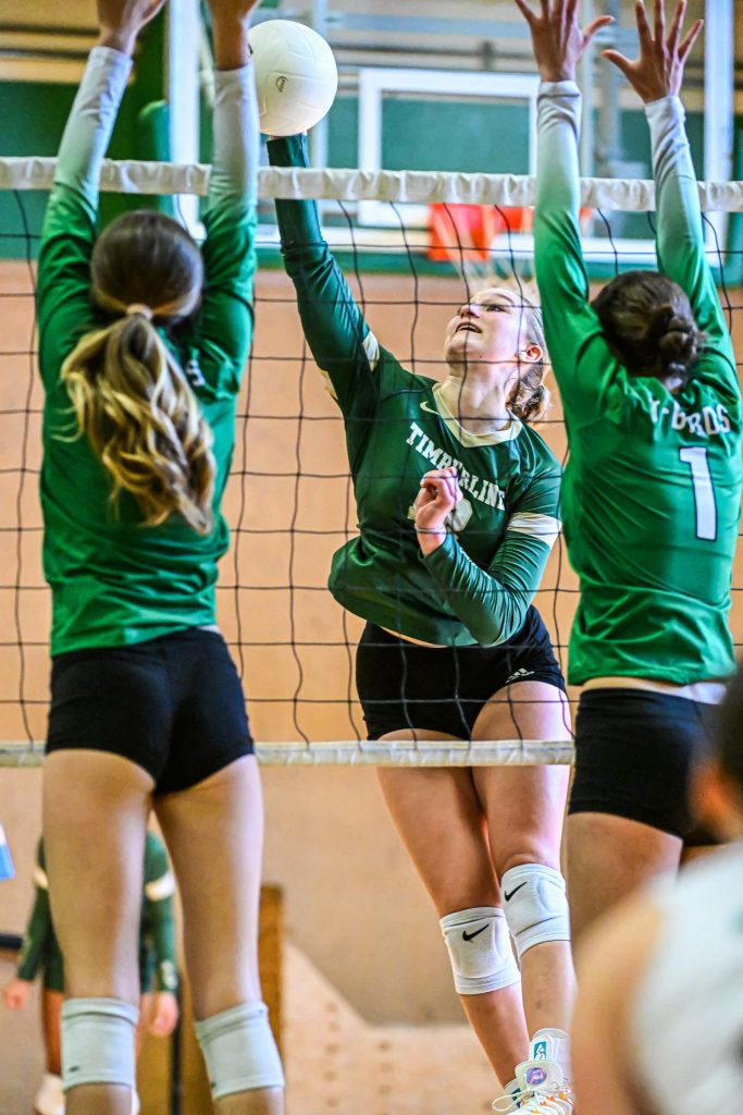 girls at the net blocking during volleyball