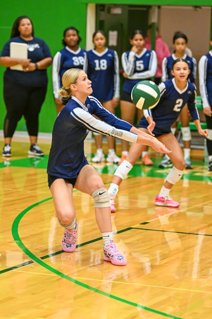 a girl bumping a volleyball