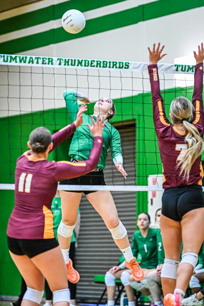 girls at the net blocking during volleyball