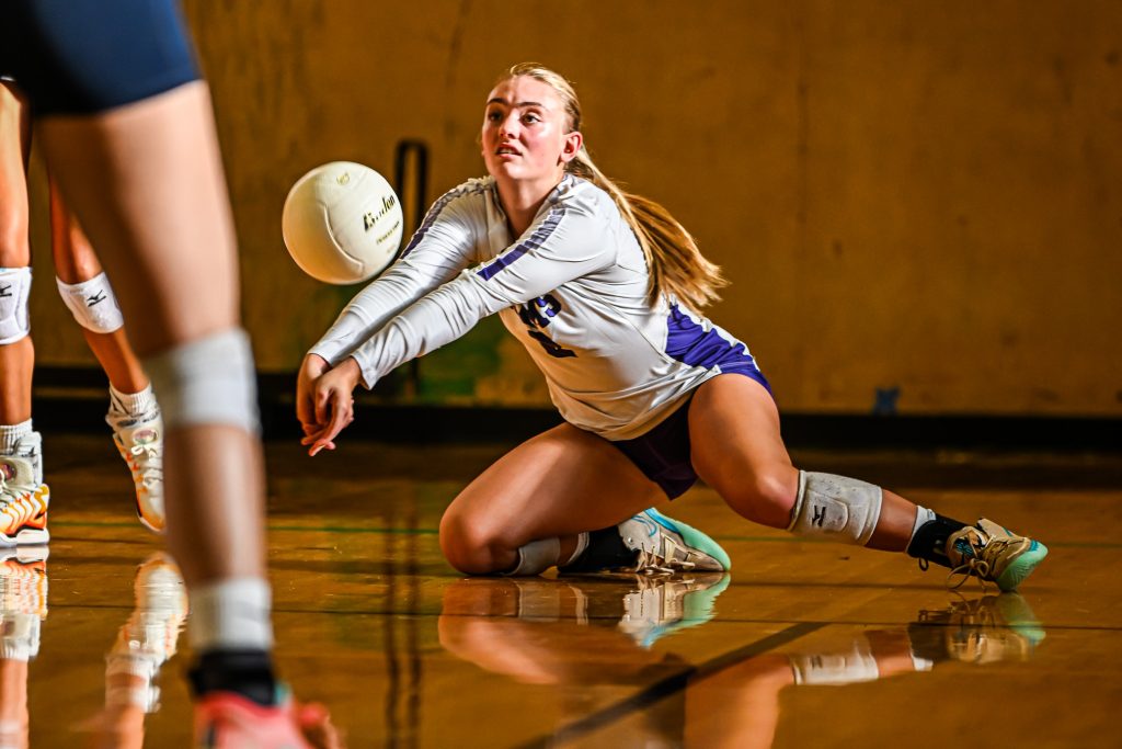 girl diving to get a volleyball