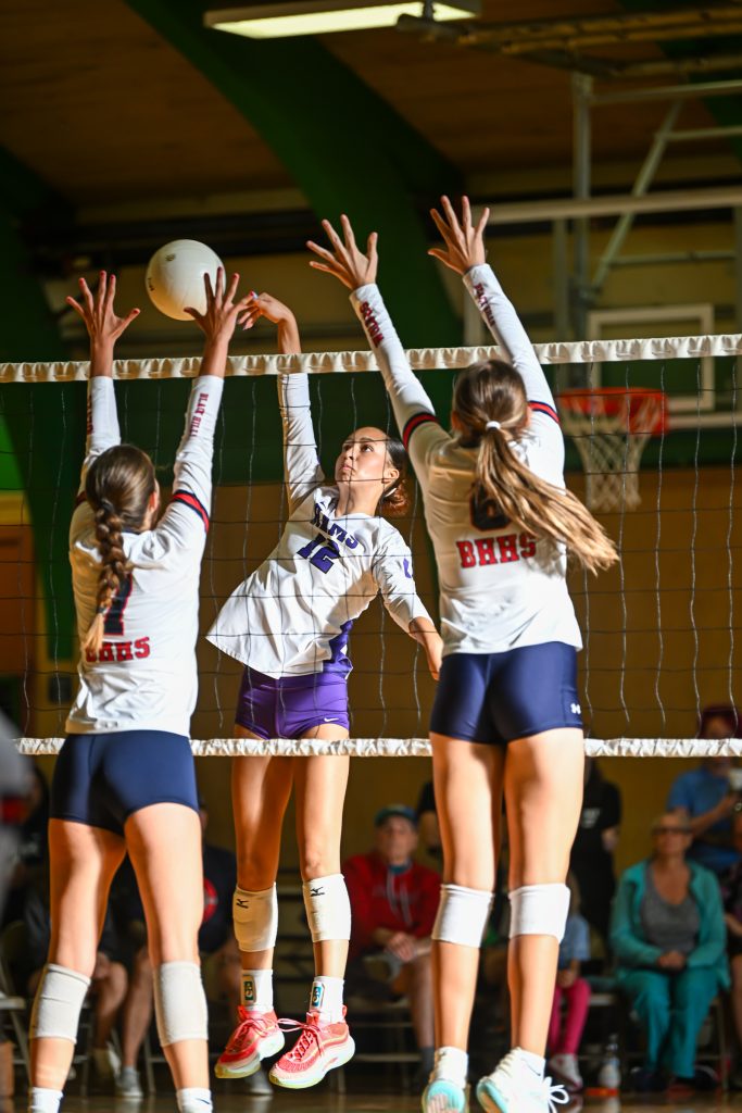 girls at the net blocking during volleyball