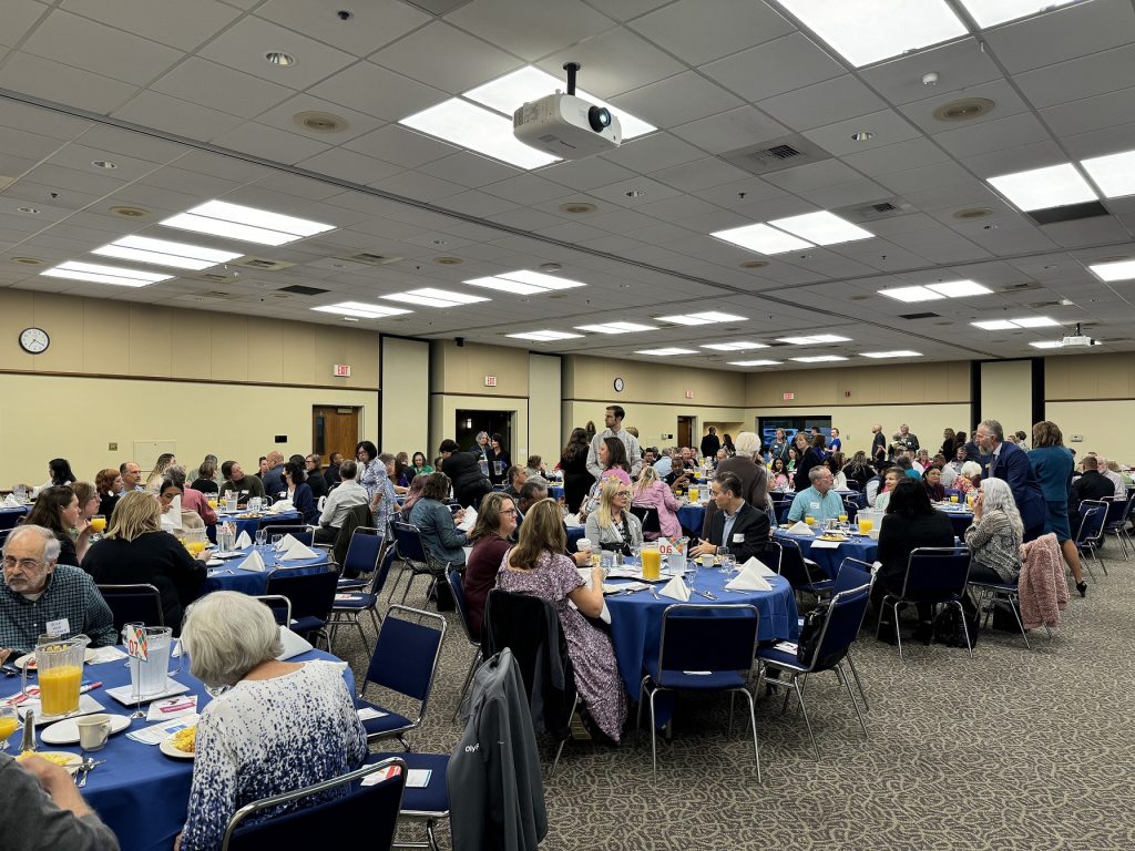 large group of people sitting at round tables